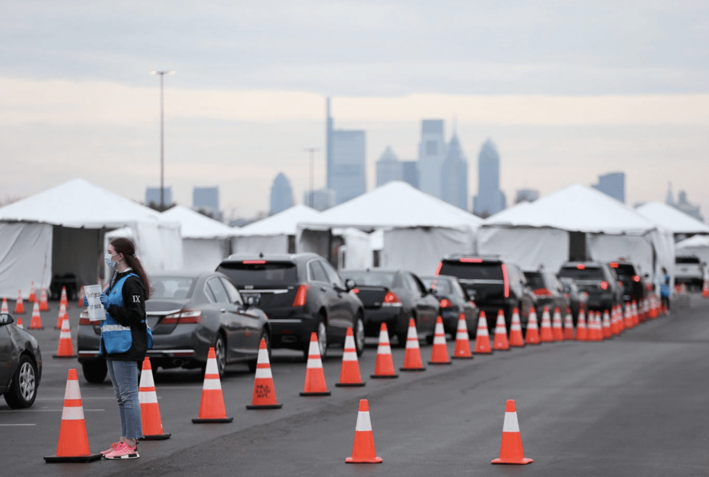 This is an image of a line of cars queued up for people trying to get a coronavirus test in Philadelphia taken by Tim Tai of the Philadelphia Inquirer